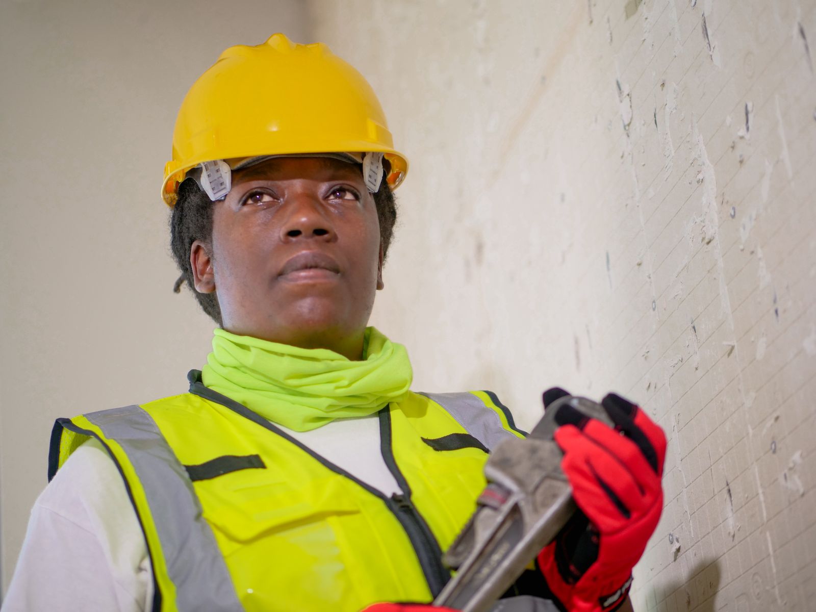 Plumber tightening a fitting with a pipe wrench