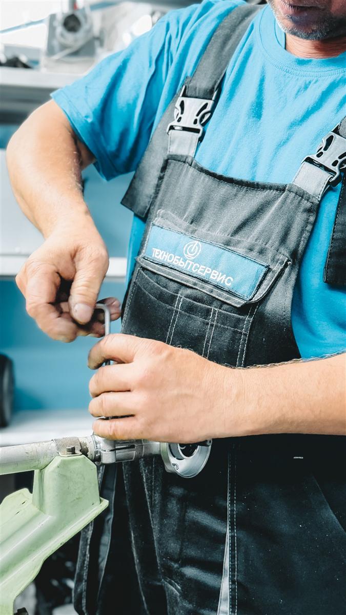Plumber repairing a section of household drain pipe
